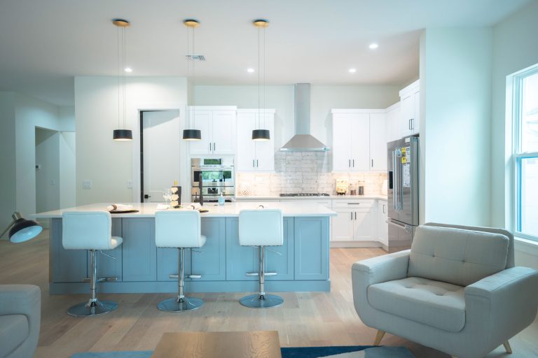 gray kitchen island white shaker cabinets pendant lights