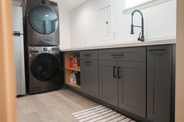 gray laundry cabinets with black washer