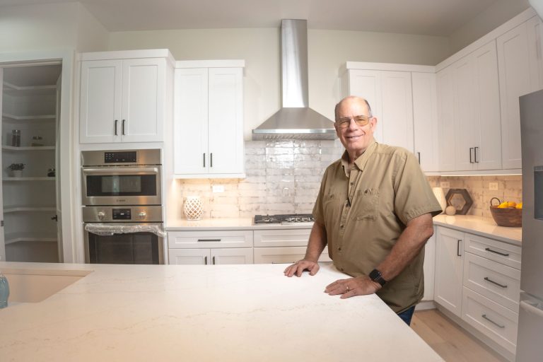 homeowner in modern white shaker kitchen