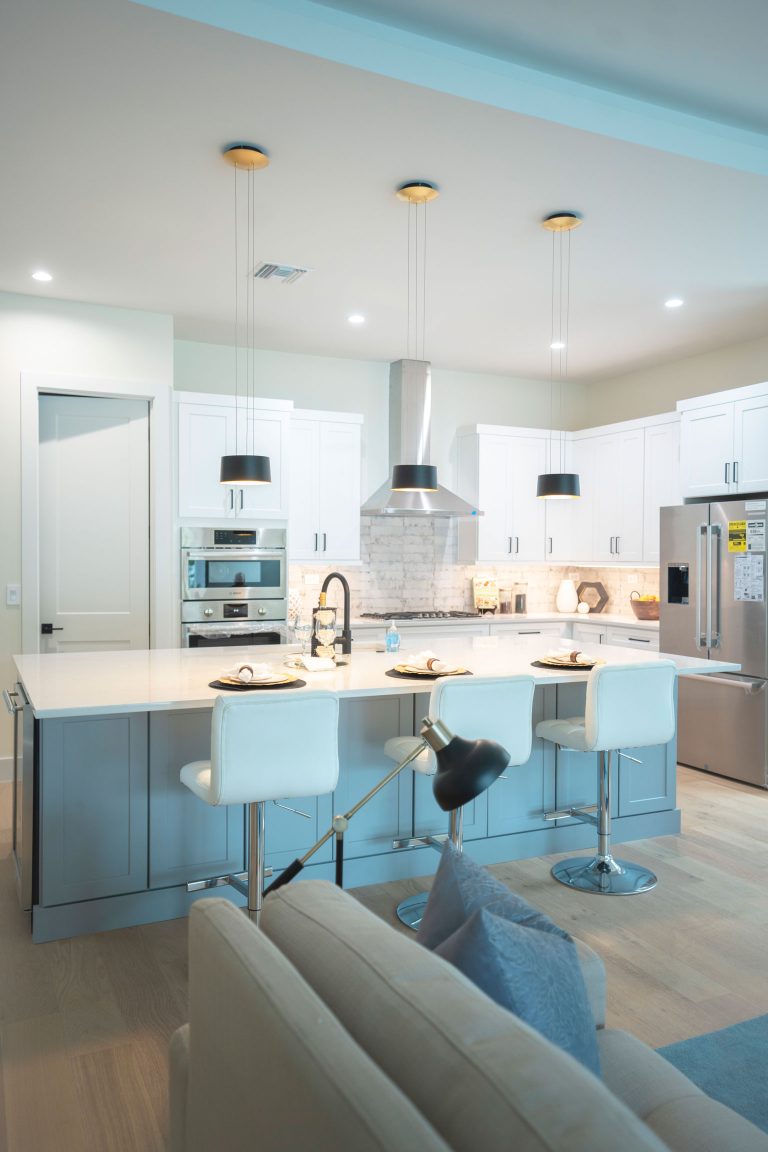 kitchen living room gray island white shaker cabinets