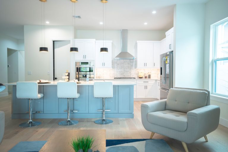 kitchen with shaker cabinets gray island pendant lights