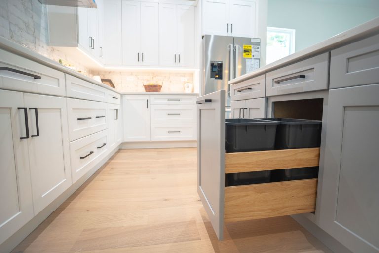 pull out trash bin in gray shaker cabinet