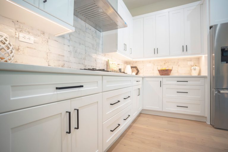 white shaker cabinets brick backsplash