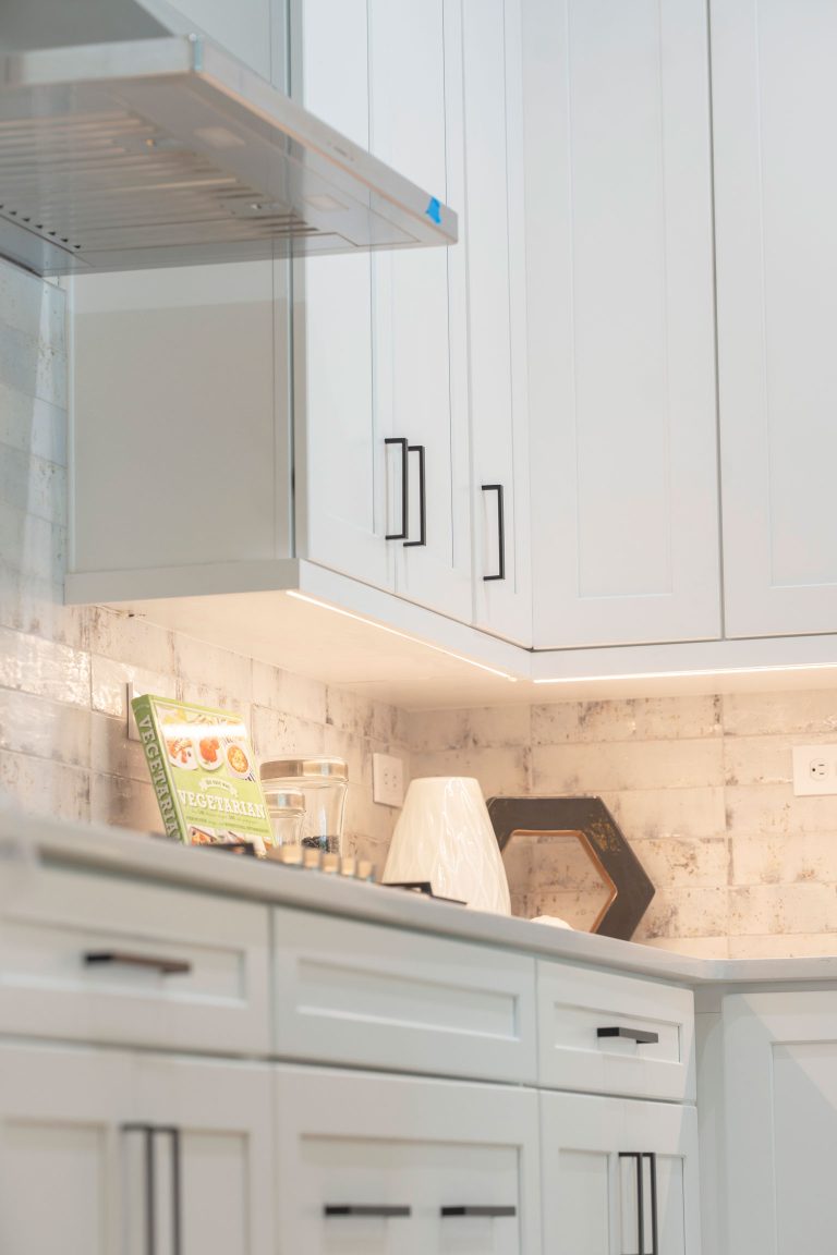 white shaker cabinets under cabinet lighting