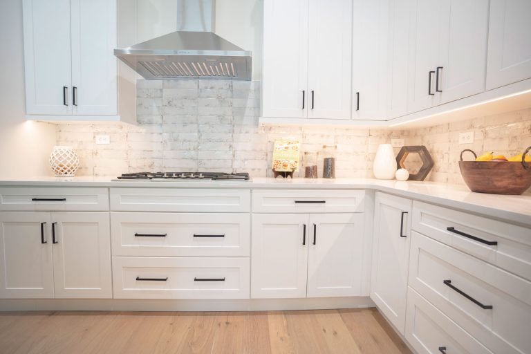 white shaker cabinets with black handles