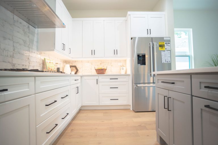 white shaker kitchen cabinets with fridge