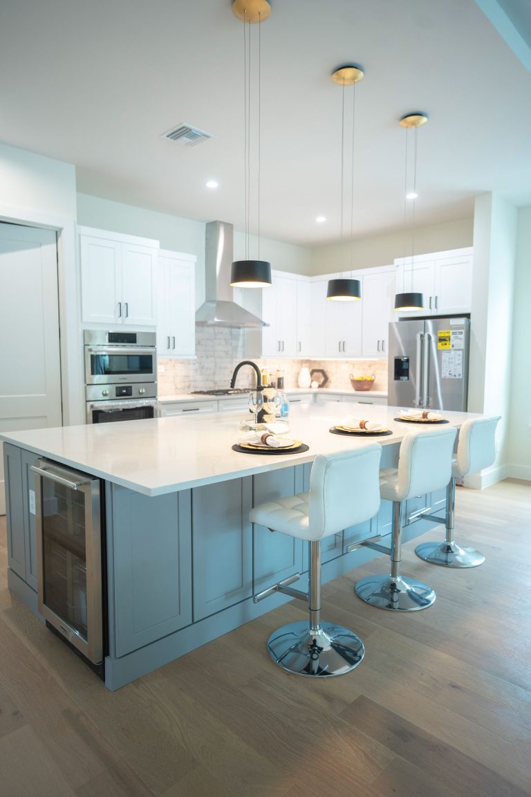 white shaker kitchen cabinets with stainless steel chair